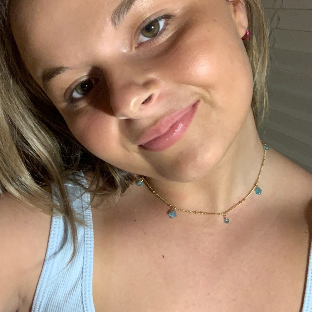 gold necklace with blue beads and stars